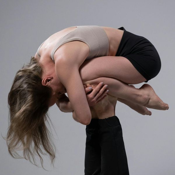 A man performing a stretching exercise, showing improved flexibility and focus.