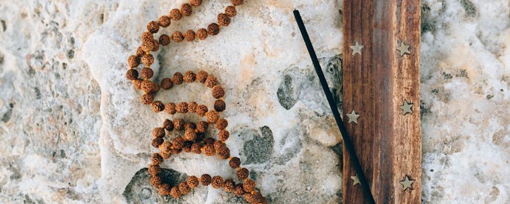 Silhouette of a person in a meditative pose against a calm, abstract background.